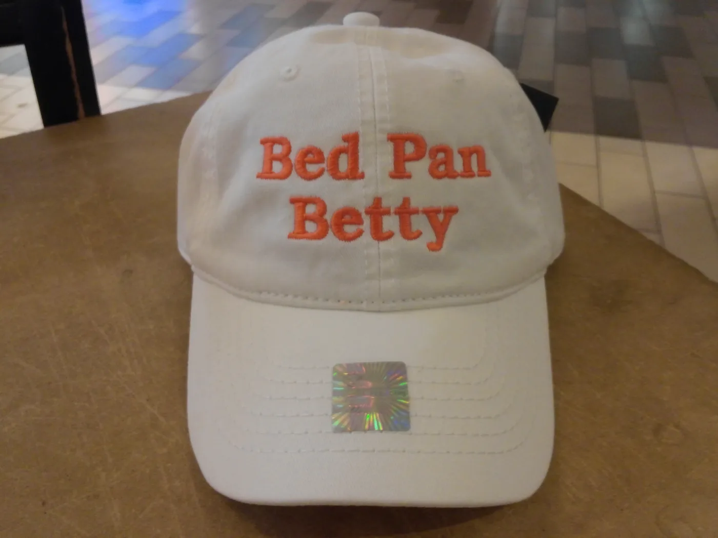Custom name embroidered on a white cap